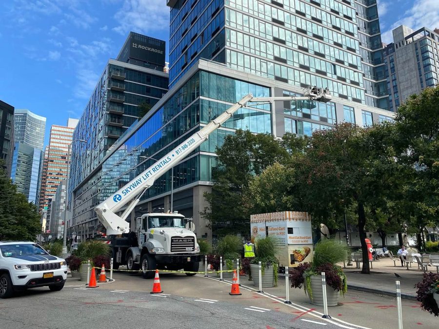 Skyway truck-mounted lift cleaning a glass office building in New York