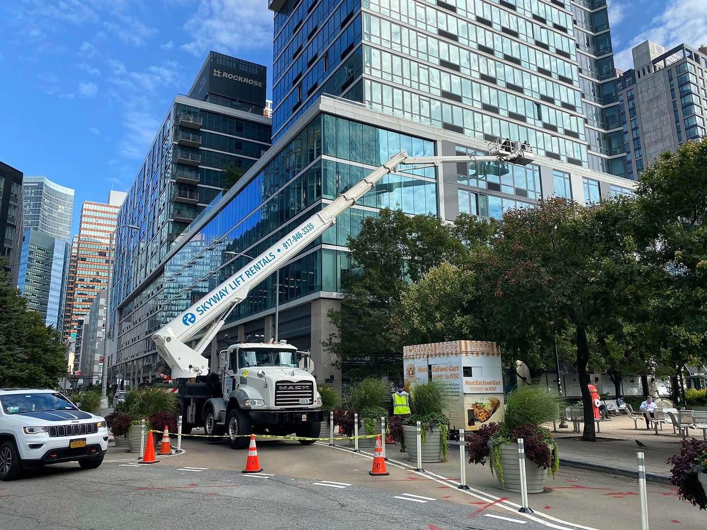 Skyway truck-mounted lift cleaning a glass office building in New York