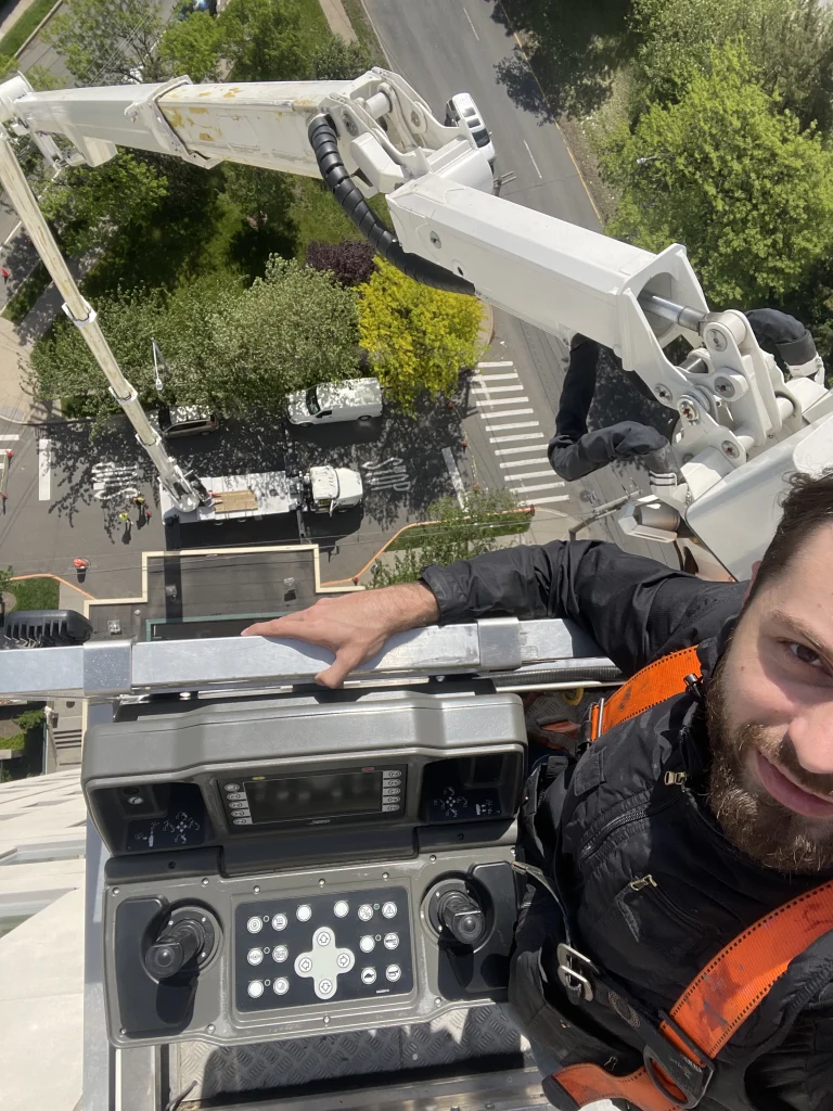 Skyway lift operator smiling in the platform basket high above the street