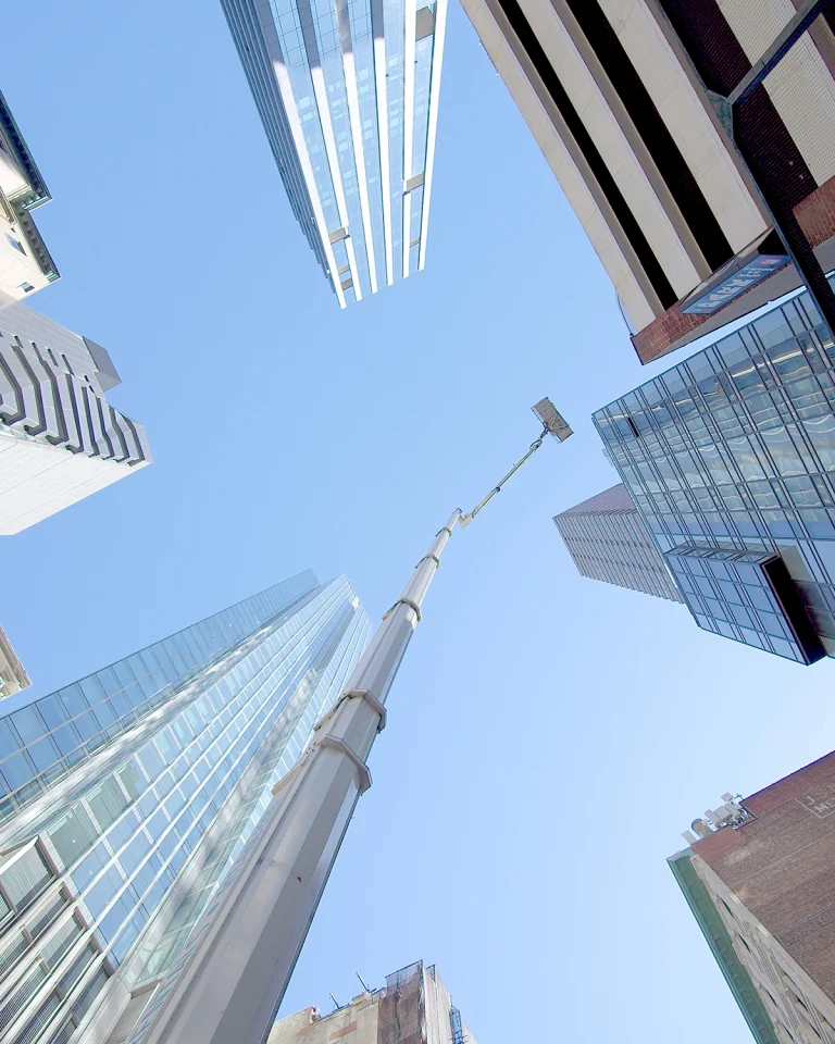Skyway aerial lift boom reaching between Manhattan skyscrapers
