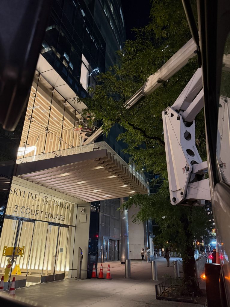 Skyway lift next to a building entrance canopy at night