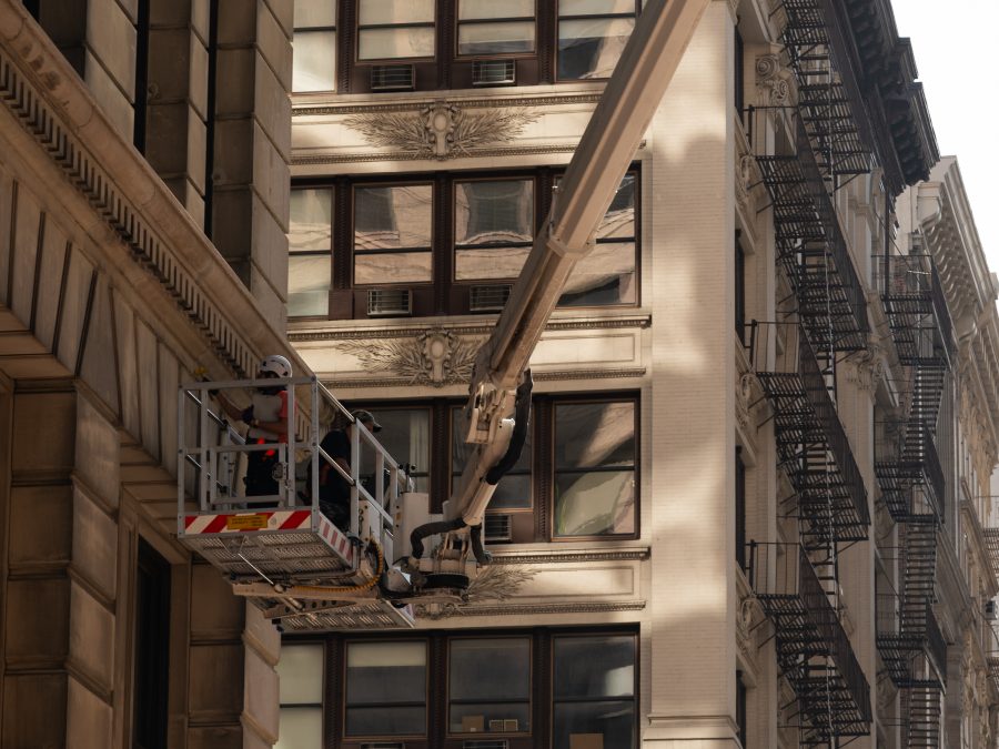 Skyway lift basket beside the cornices and ledges of a classic stone building in New York