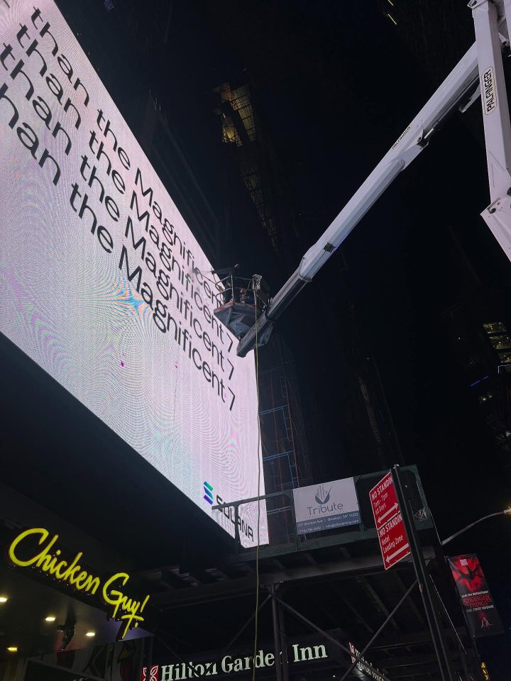 Skyway truck-mounted lift beside a large LED billboard in New York