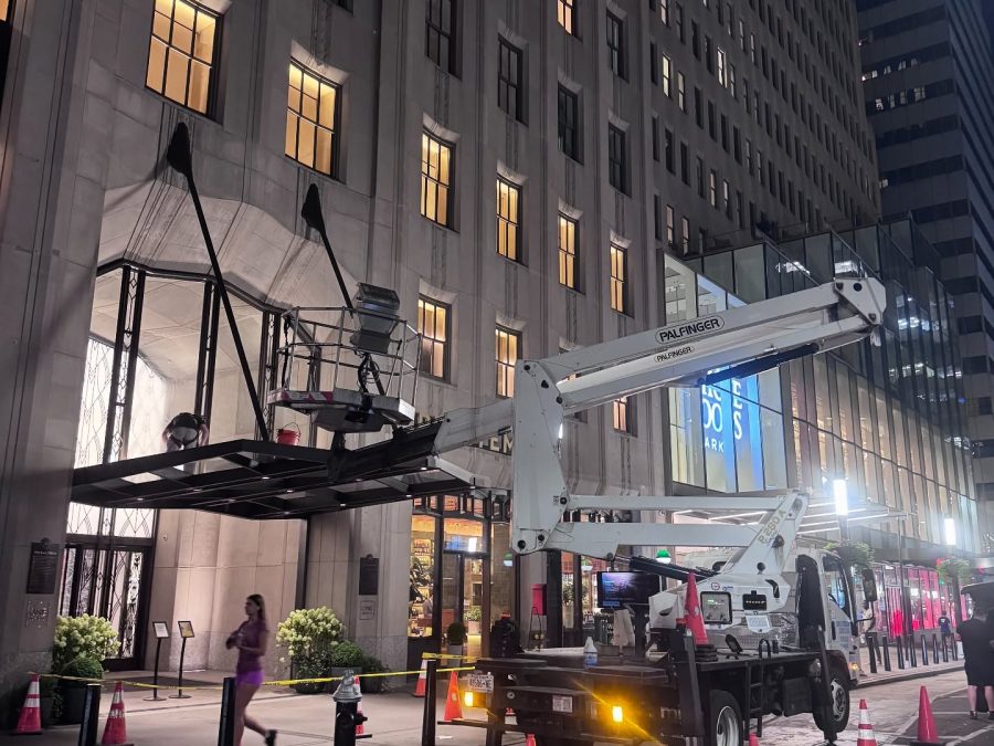 Skyway lift cleaning a building entrance canopy at night in Manhattan