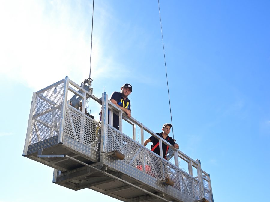 Skyway crew on a suspended platform working on a building facade